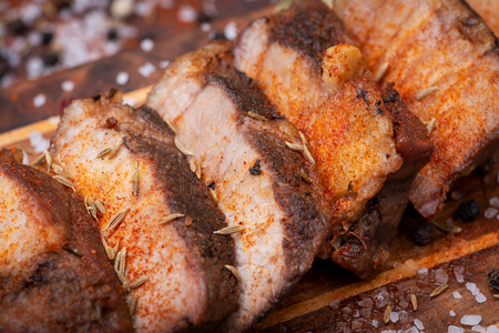 Oven Roasted Pork with spices on wooden cutting board.の写真素材