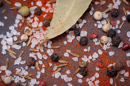 Close up of Spices (Paprika, Thyme, Coarse Sea Salt, Rainbow Peppercorns) on natural stone background.の写真素材