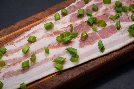 Uncured Apple Smoked Bacon garnished with Green Onion Scallions.の写真素材