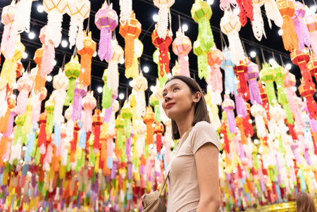 Happy beautiful asian woman smiling and looking paper lanterns decorate a festival in northern...