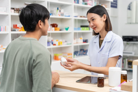 Beautiful asian female pharmacist analyzing about customer symptoms for discussion of the medicine...