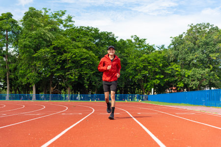 Young Asian men are exercising with outdoor running with a running track background in the morning....