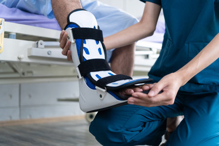 Young asian man patient receives physical therapy with a long ankle splint under the care of a...