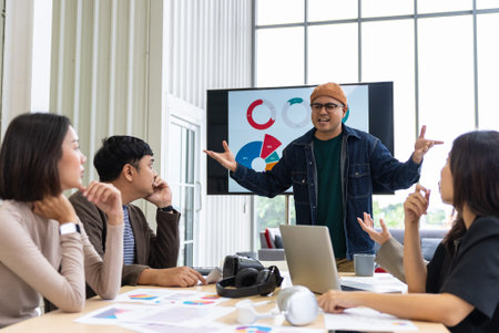 Group of business people discussing the charts and graphs showing the results of their successful teamwork