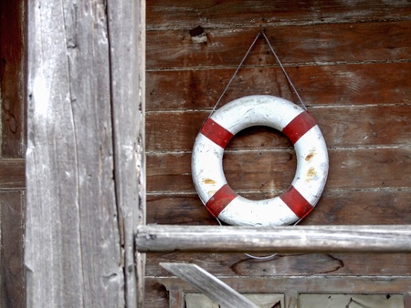 Life Buoy attached to old Wooden Paneled Wall