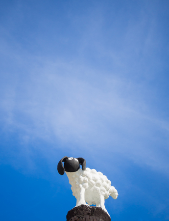 little sheep statue in blue sky backgroundの写真素材