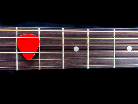 Pick guitar on finger board backgroundの写真素材