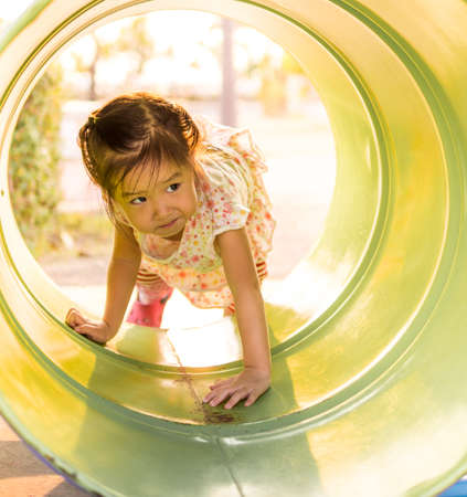 Happy kid, asian baby child playing on playgroundの写真素材