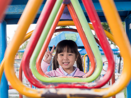 Happy kid, asian baby child playing on playgroundの写真素材