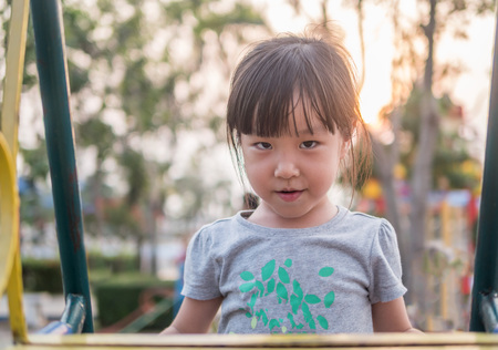 Happy kid, asian baby child playing on playgroundの写真素材