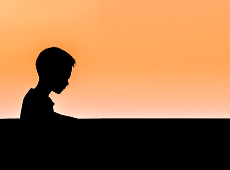 isolated of a boy looking for something , sun light backgroundの写真素材