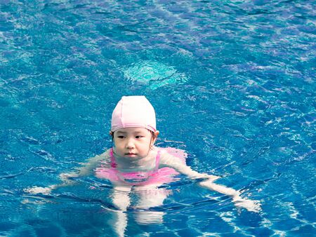 Asian girl is playing in the pool, very happyの写真素材