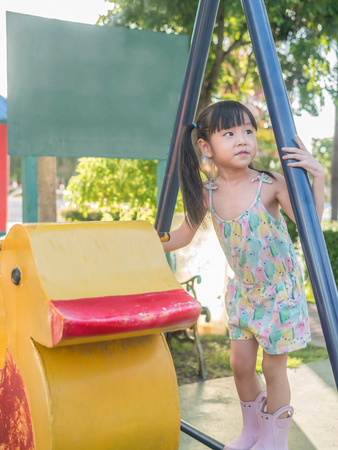 asian baby child playing on playgroundの写真素材