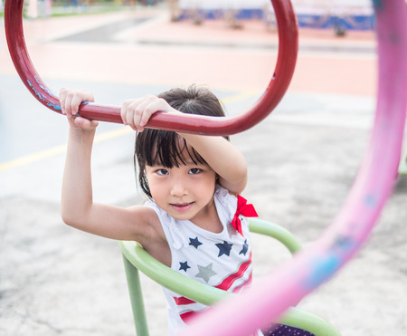 Happy asian baby child playing on playgroundの写真素材