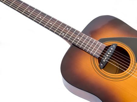 A 6-string acoustic guitar sound hole with pickup in white background , selective focus
