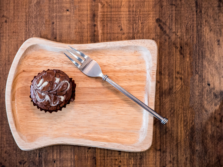 Homemade artisan dark chocolate brownies , on wood dishの写真素材