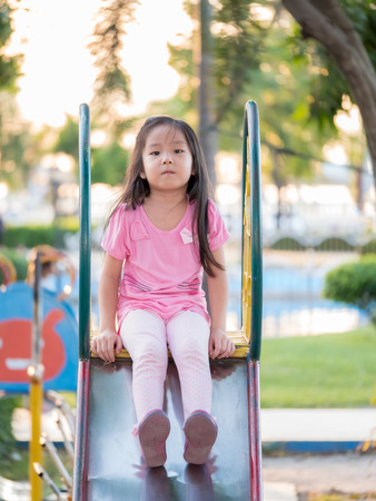 Happy kid, asian baby child playing on playgroundの写真素材