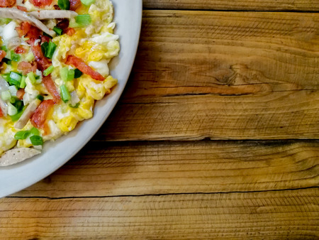 Indochina pan-fried egg with toppings in my homemade Thai style, on wood tableの写真素材