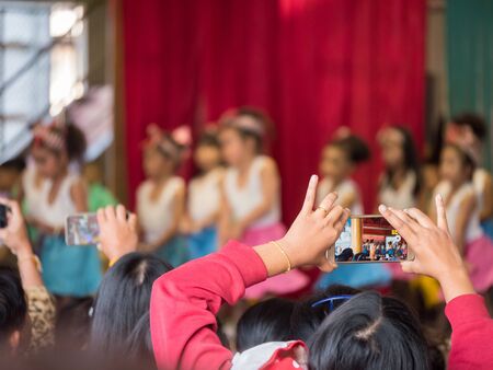 Thailand, Chonburi : The parents try to take picture or take video of their kids in  acting day at...