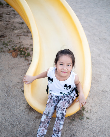 Happy kid, asian baby child playing on playgroundの写真素材