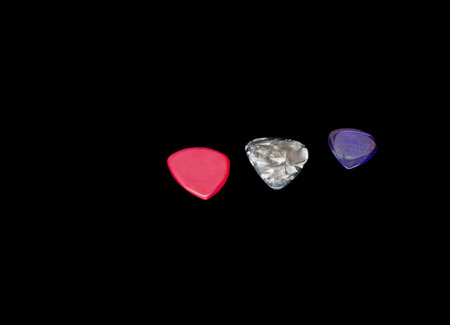 Three pick guitar SIze and thickness red perl and purple color on black background.の写真素材