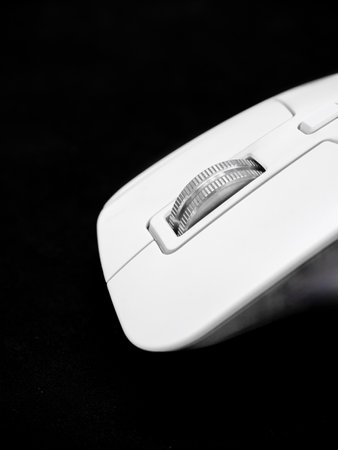 close up shot detail wheel of wireless computer mouse , made from stainless steel, Black background