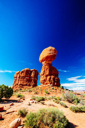 Balanced Rock - a boulder estimated at 3500 tons weight - sits perched on a precarious pedestal - Arches National Park, Utah, USAの写真素材