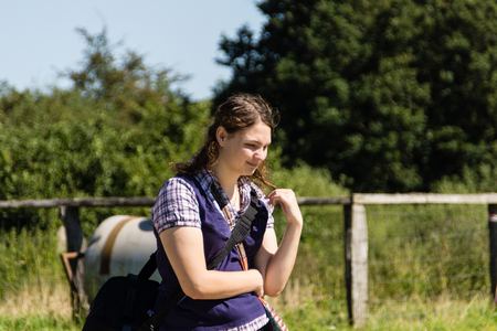 A young woman is running around in an open air museum 