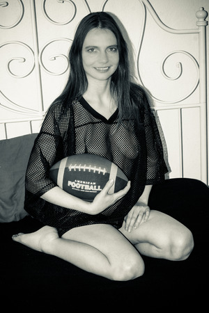 a woman is posing naked and nude as an American Football playerのeditorial素材