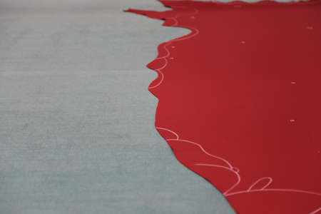 Red leather with chalk lines on gray surfaceの写真素材