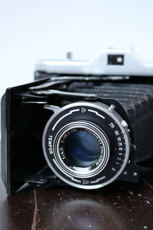 Vintage photo camera on a brown wooden surfaceの写真素材