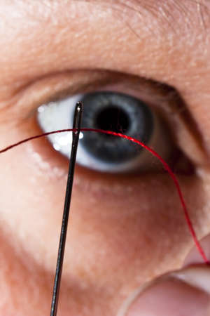 Close up of threading a needleの写真素材