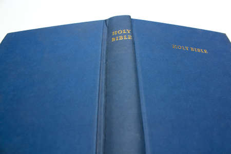 Blue bible against a white background