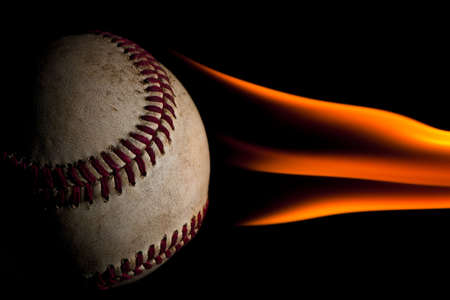 Flaming baseball against a black backgroundの写真素材