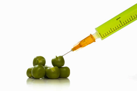 Essence of pea being extracted with a hypodermic needleの写真素材