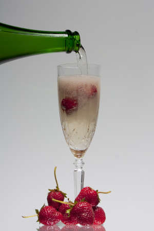 Strawberries and champagn against a graduated backdropの写真素材