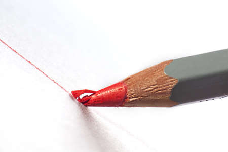 Pencil with red lead smashing whilst drawing a line in extreme close upの写真素材