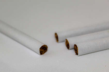 Cigarette butts on a white background. The concept of smoking.