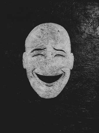 Smiling face on a dark background. Monochrome image.の写真素材