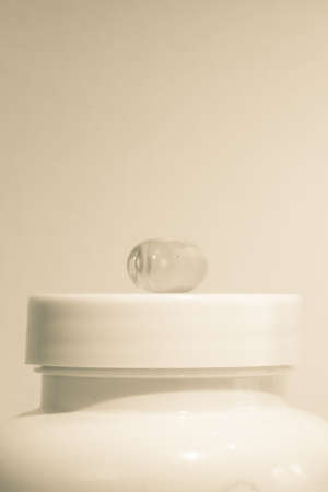 Cosmetic bottle with dropper on beige background.の写真素材