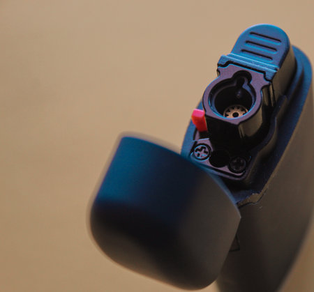 Close up of an electronic object in a black case on a brown backgroundの写真素材