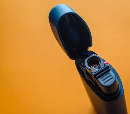 Close-up of a camera flash on a yellow background with copy spaceの写真素材