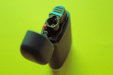 Black lighter on a green background. Close-up. Selective focus.の写真素材