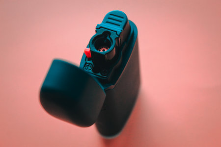 Close up of a black electronic cigarette lighter on a red background.の写真素材