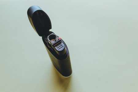Close up of a black lighter on a white background with copy spaceの写真素材