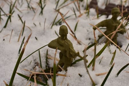 A Close up shot of Toy Army Men marching through the deep snow.の写真素材