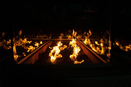 A Shot of a Glass Fire Pit at a Restaurant Reflecting off all its Surfacesの写真素材