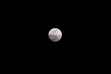 The Pink Supermoon on a pure black skyの写真素材