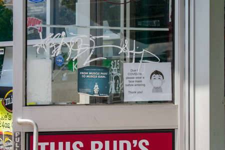 ELKINS PARK, PENNSYLVANIA-MAY 11, 2020: A Sign On the Door of a Business States Face Masks are...