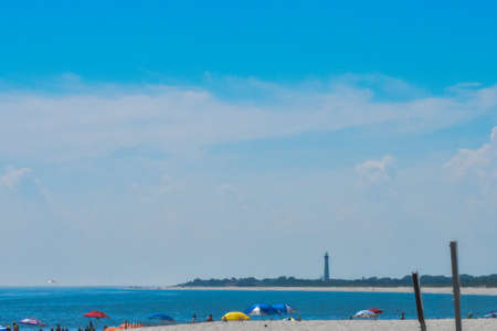Looking Over the Blue Sea on a Beach in New Jersey at a Lighthouseの写真素材